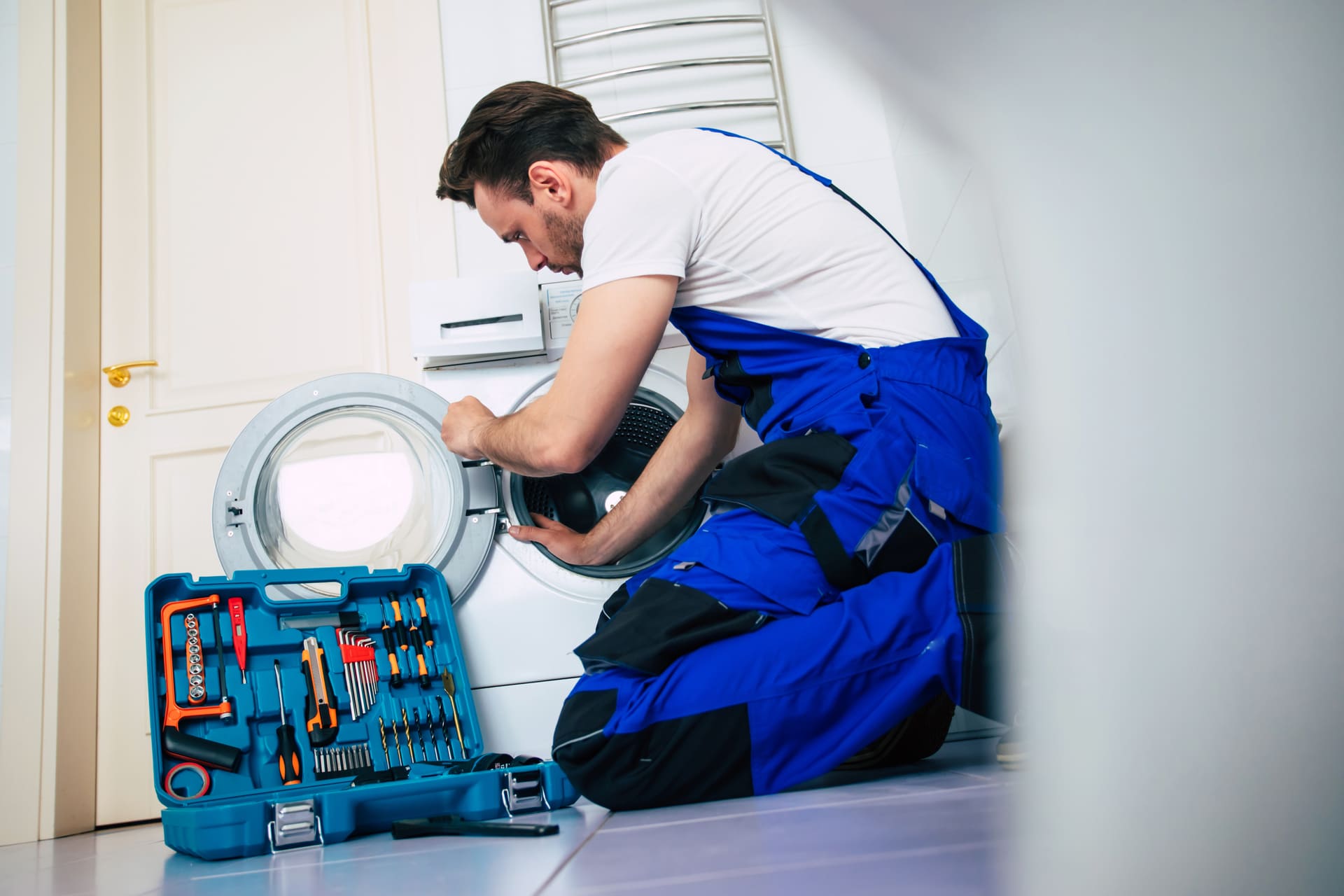 young-handsome-repairman-worker-suit-with-professional-tools-box-is-fixing-washing-machine-bathroom-1
